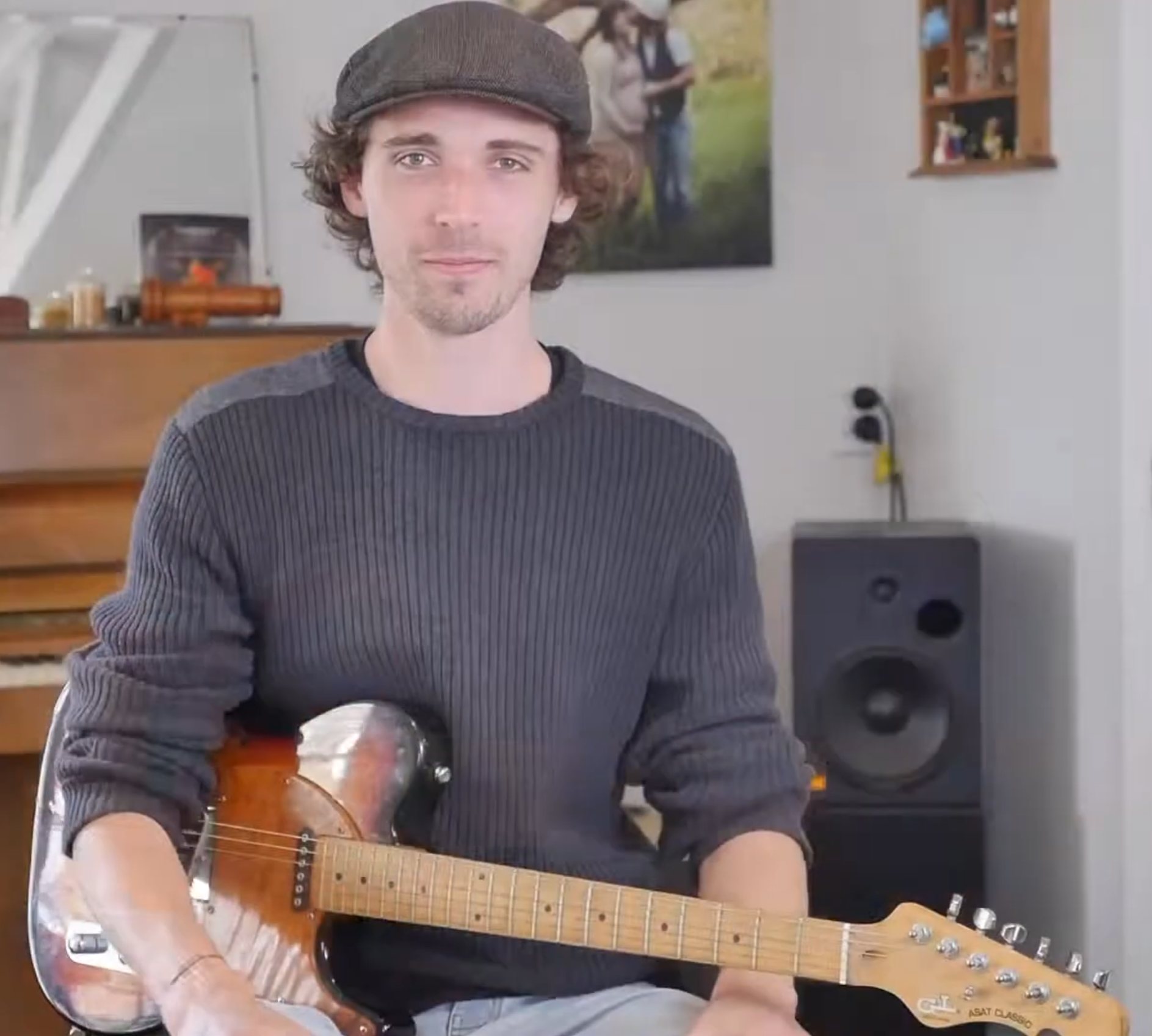Jo Jenkins holding an electric guitar in a music room